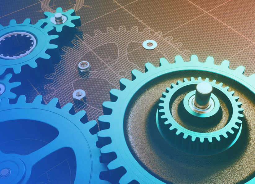 Close-up of interlocking industrial gears on a technical blueprint background