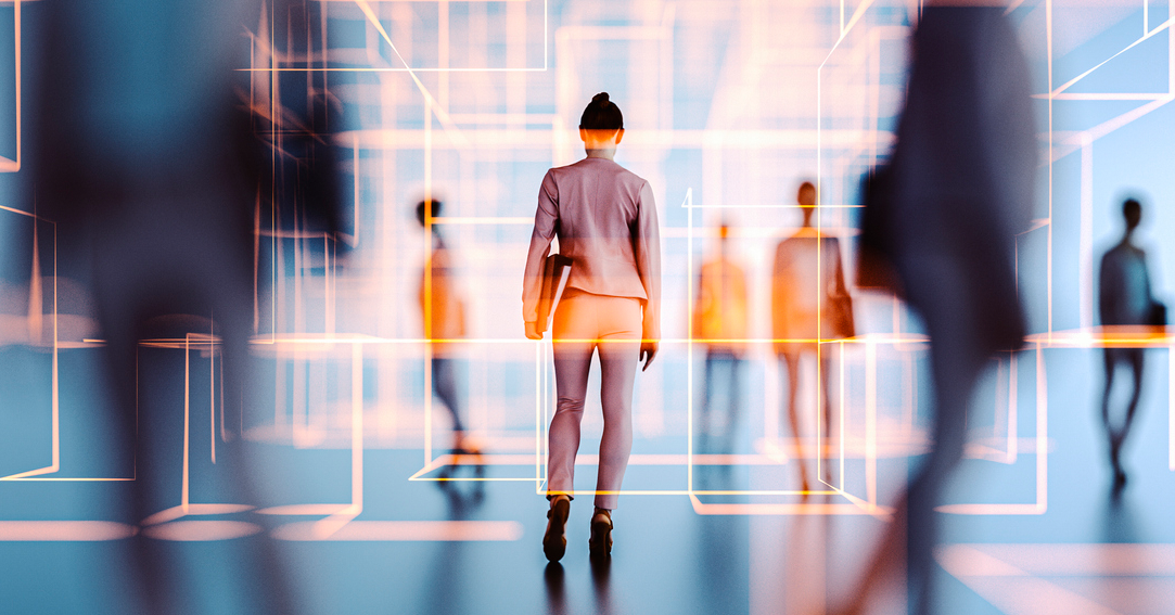 A woman walks through a futuristic, digital environment with glowing geometric outlines and blurred figures in the background, illuminated by soft blue, white, and orange light.