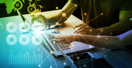 Two professionals collaborating on a laptop with digital analytics dashboards